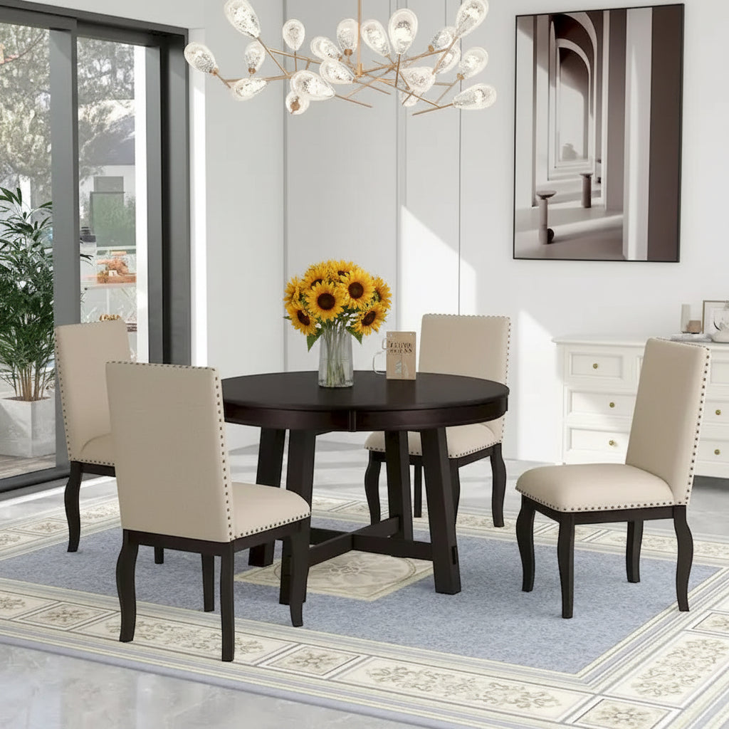 Dining room with a round wooden table and four chairs on a patterned rug.